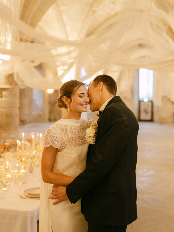 A newlywed American couple sharing a romantic kiss during their wedding evening